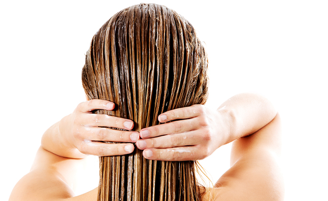 woman applying hair conditioner