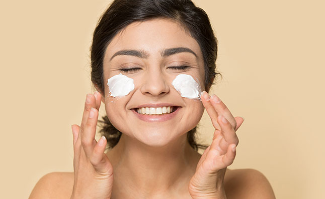 Woman Applying Face Cream